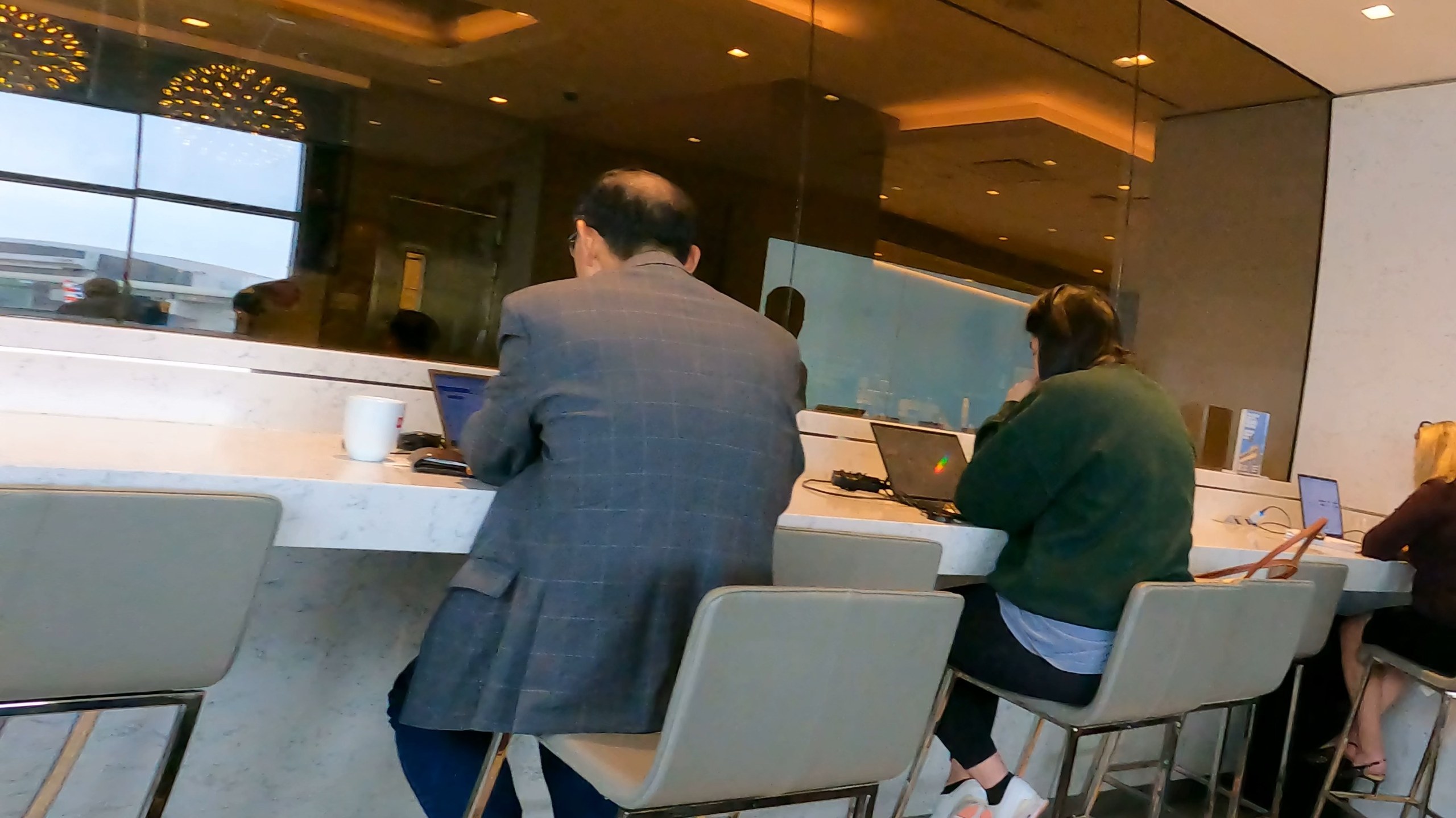 Counter height window seating with outlets at the United Club at DFW