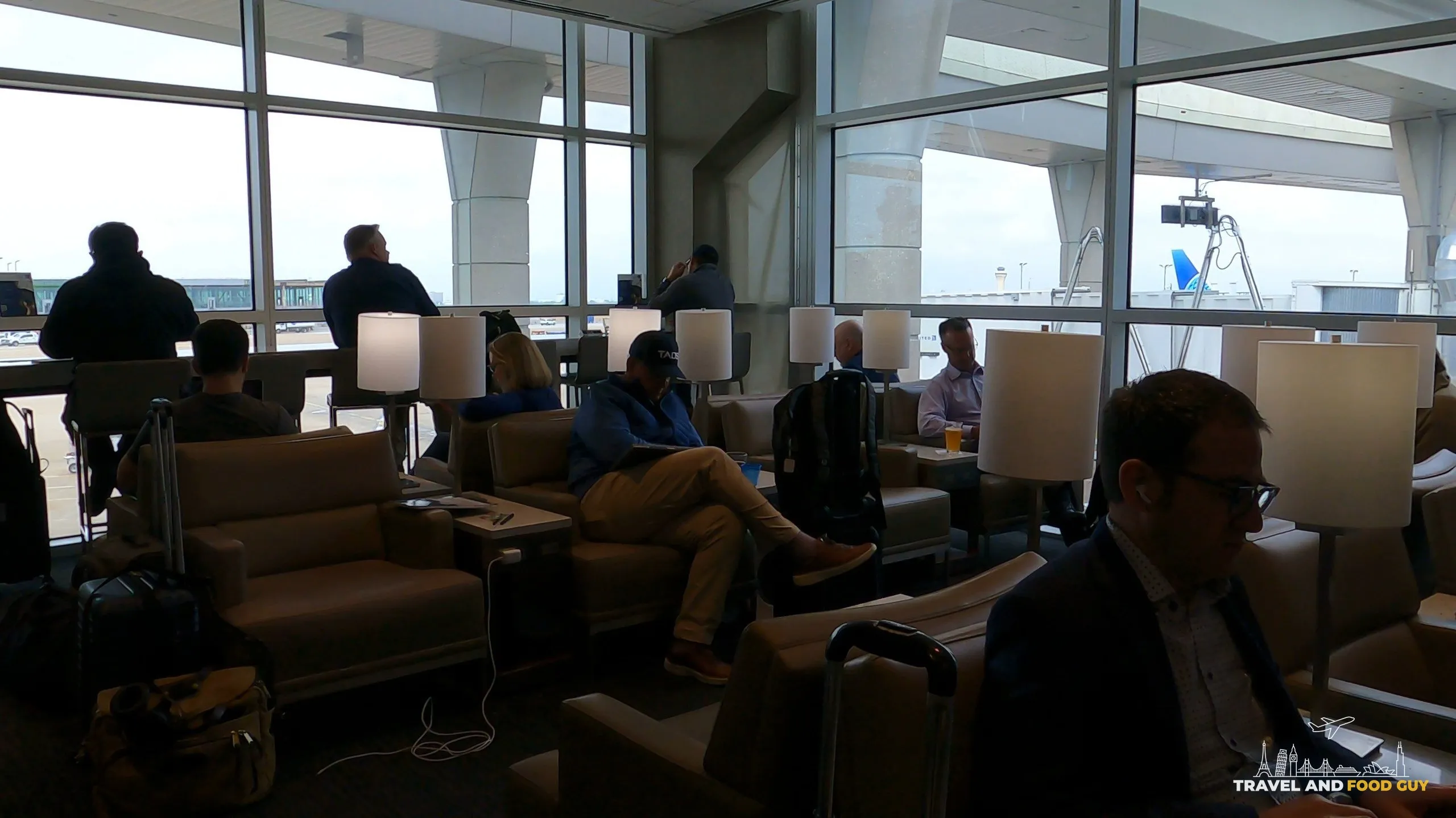 Window lounge chairs facing the tarmac at the United Club at DFW