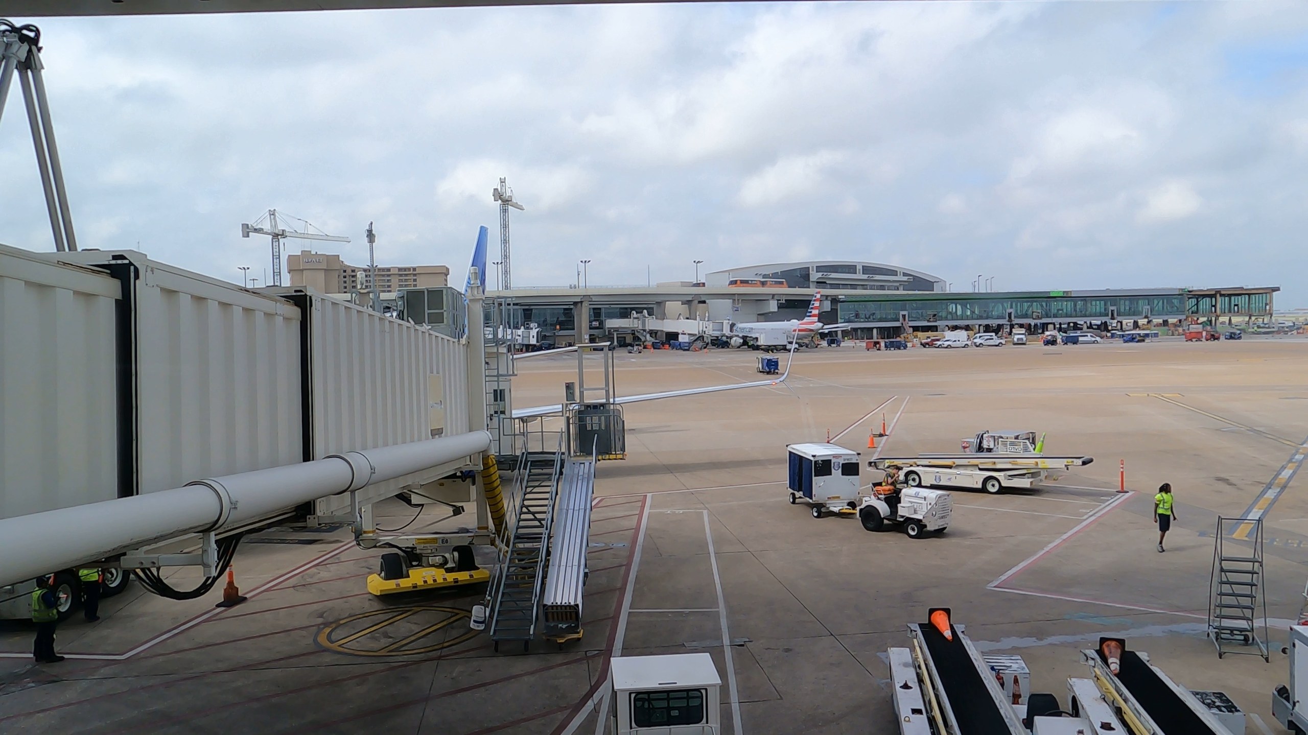Window view of jet bridges and an American jet from the United Club at DFW