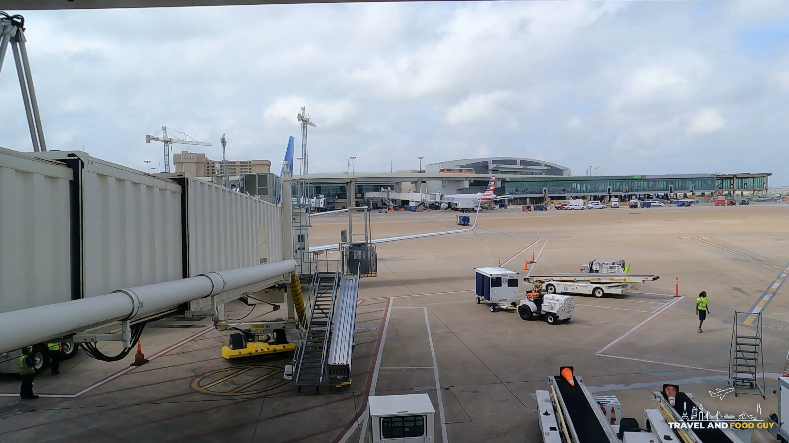 Window view of jet bridges and an American jet from the United Club at DFW