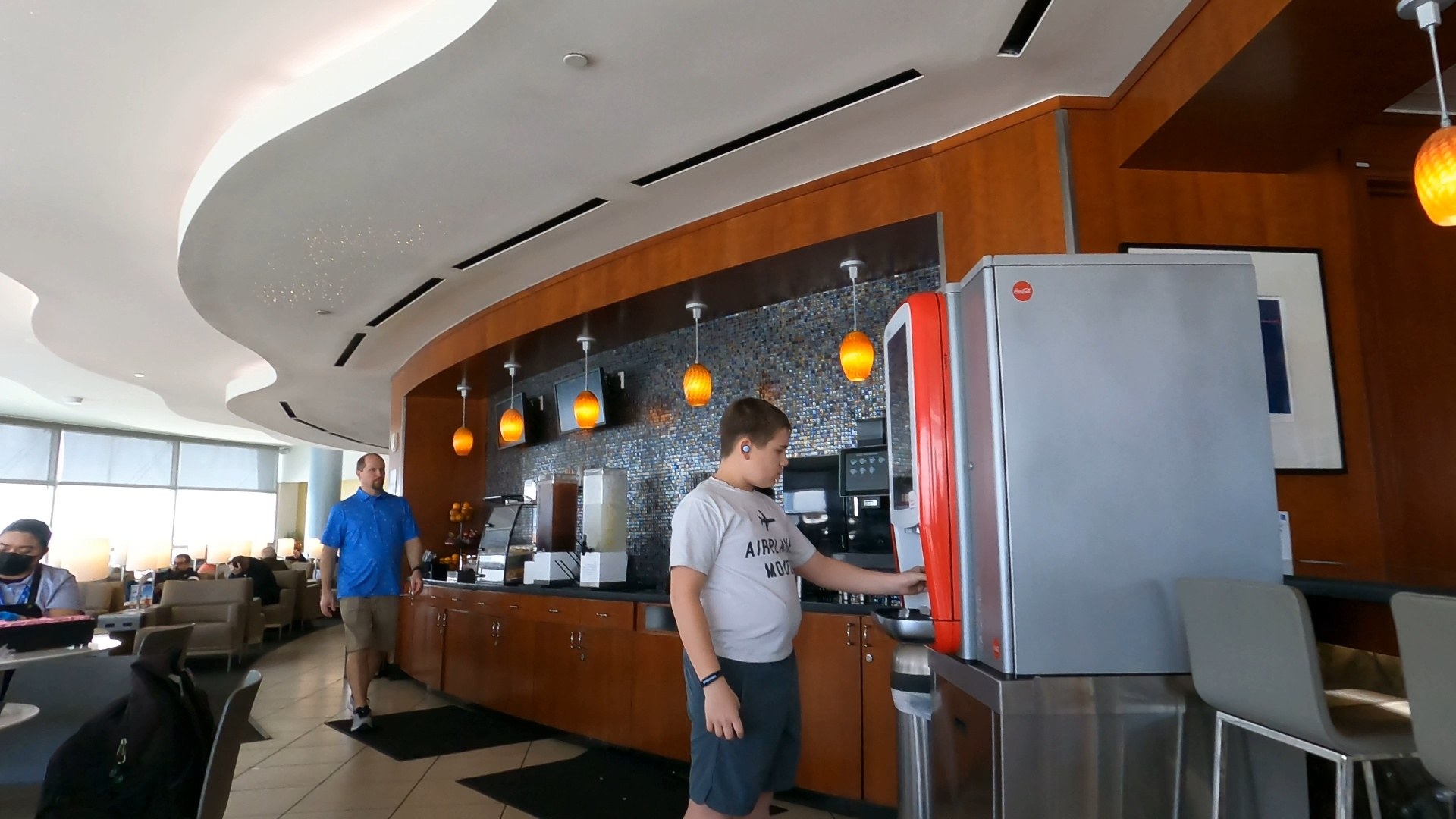 Josh in his Airplane Mode shirt getting a coffee at the espresso machine inside the United Club LAS