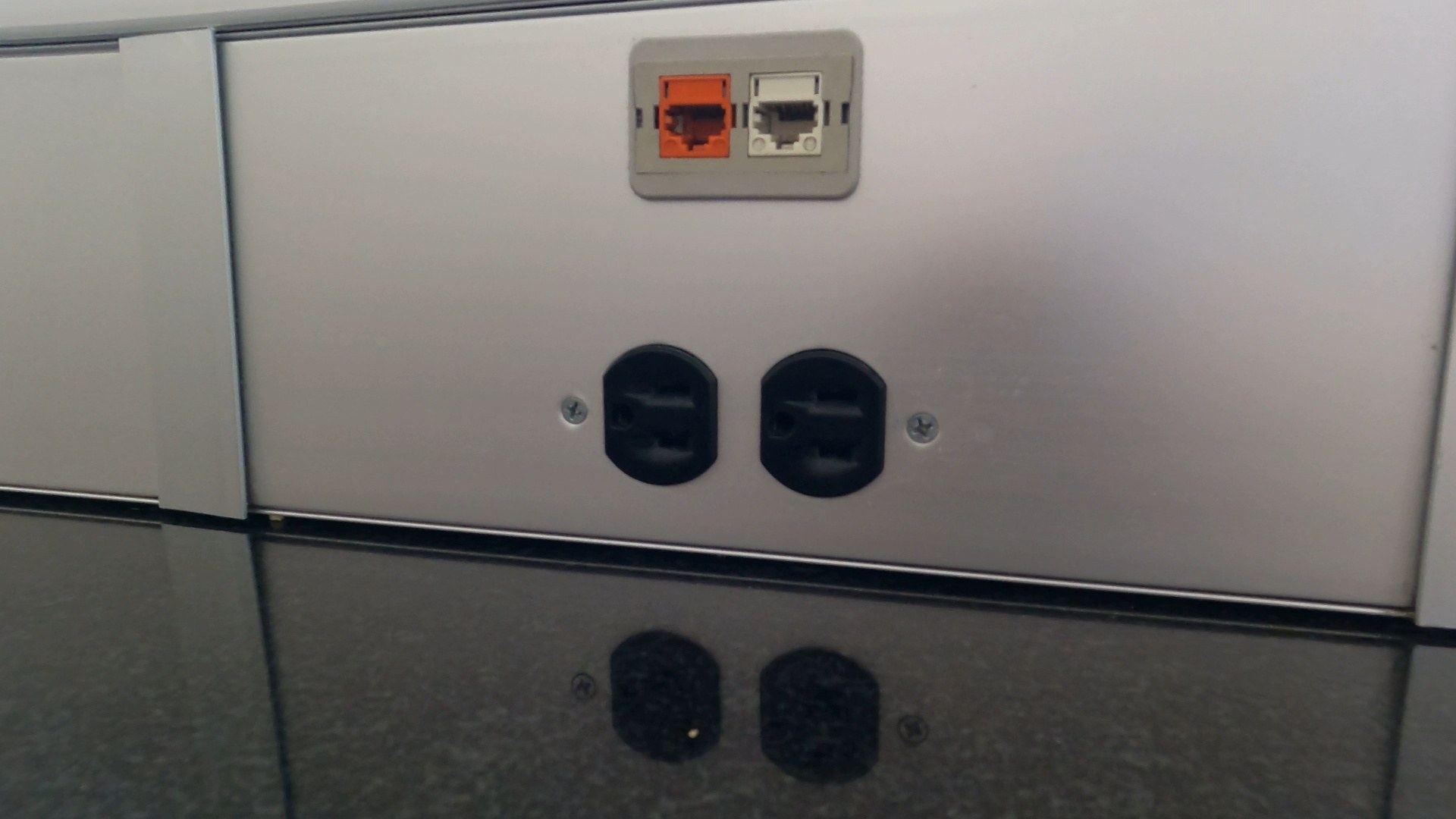 Power outlets and USB ports built into the seating at the United Club LAS