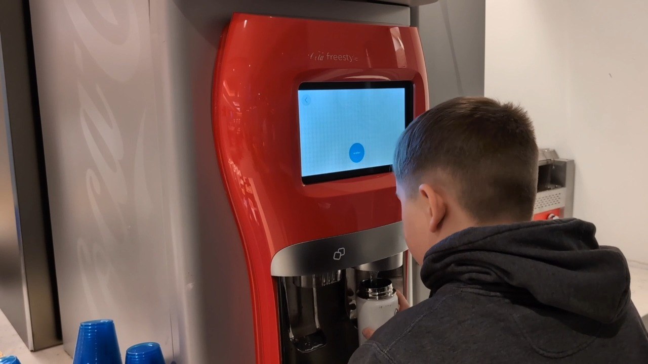 My son Josh filling his water bottle at the Coca-Cola Freestyle machine at the United Club at ORD Gate B18.