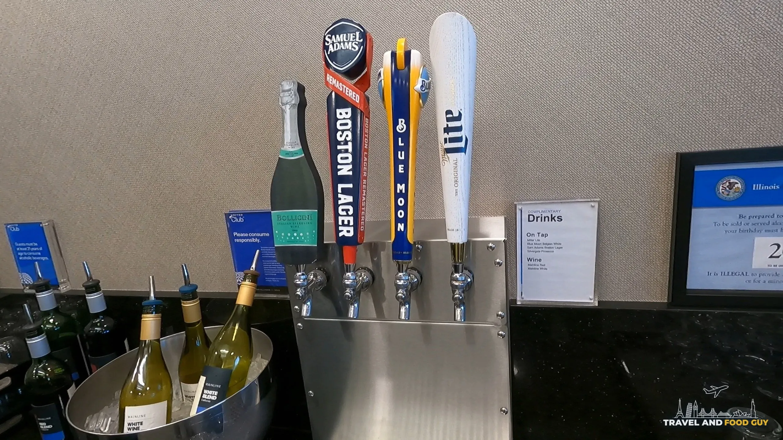 Beer taps at the United Club at ORD Concourse F (Samuel Adams Boston Lager, Blue Moon, Miller Lite) with a champagne bottle and white wines chilling on ice.