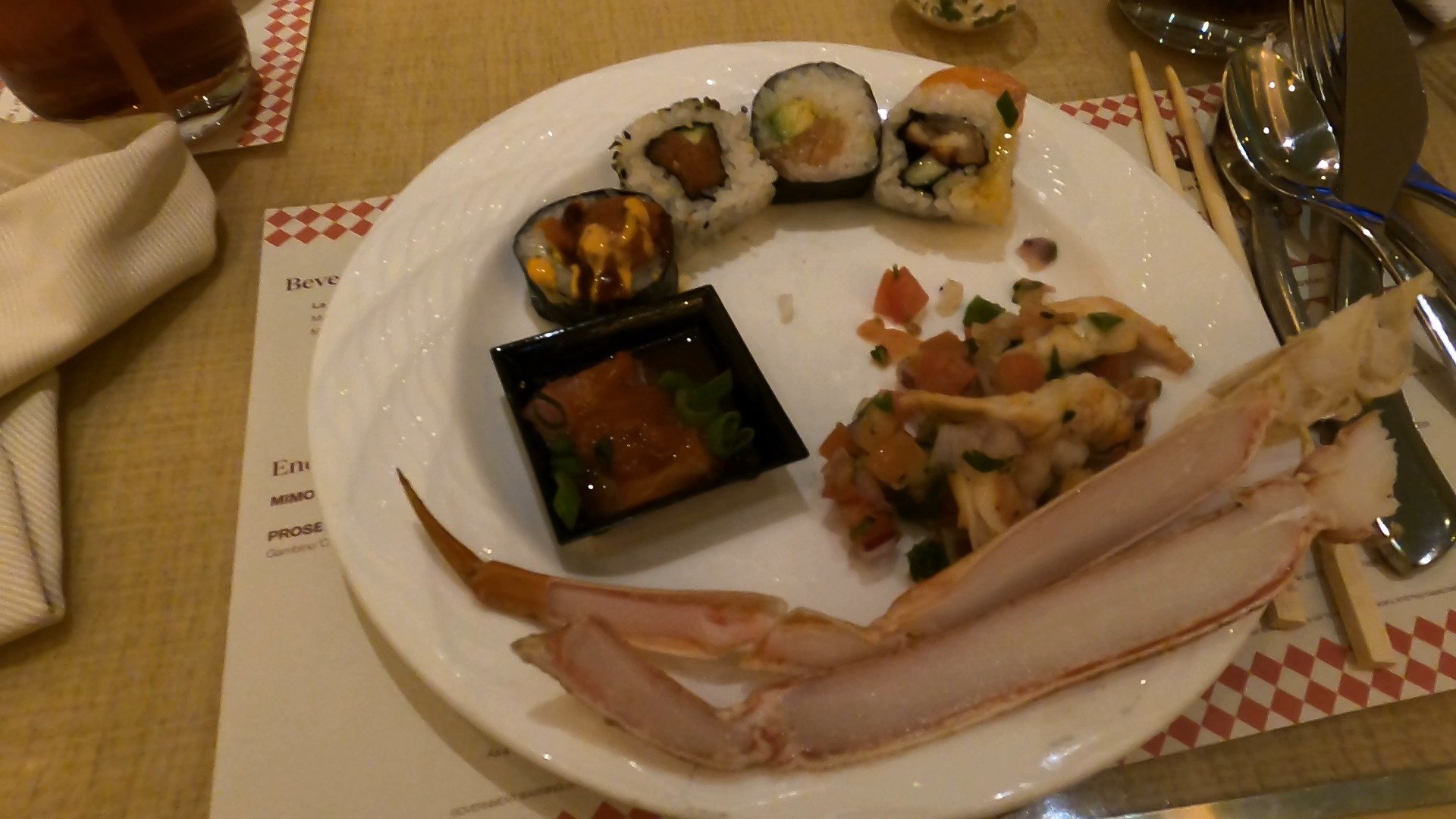 A plate from The Buffet at Wynn with sushi rolls, ceviche, and a fresh crab claw