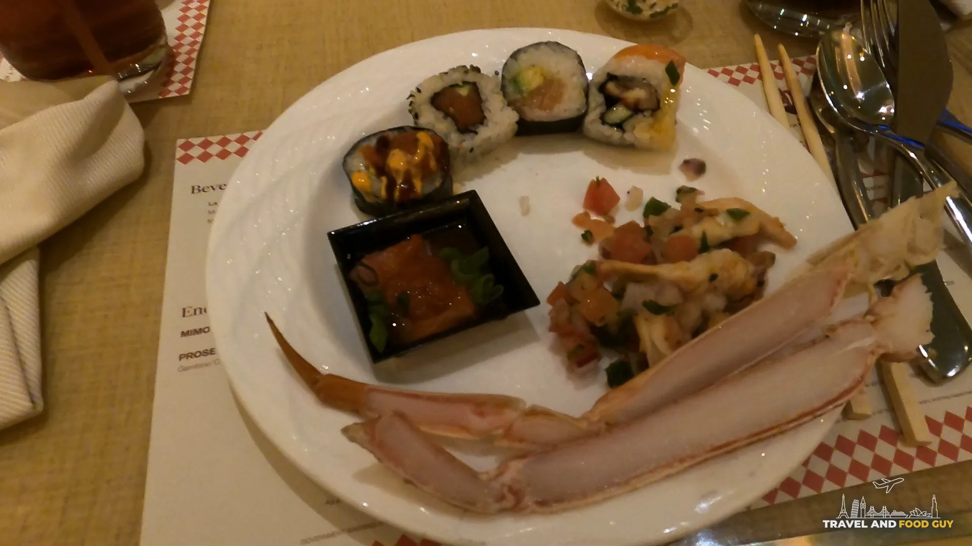 A plate from The Buffet at Wynn with sushi rolls, ceviche, and a fresh crab claw