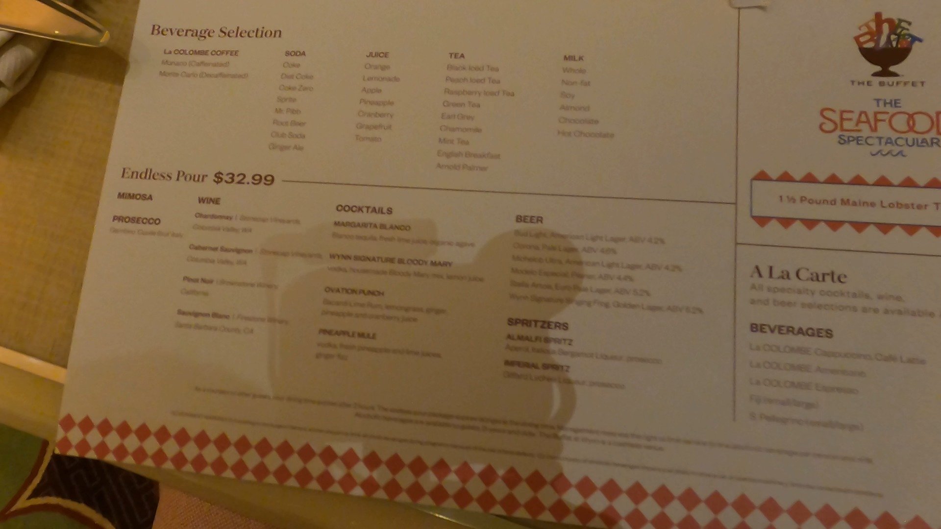 Beverage menu at The Buffet at Wynn showing the $33 endless pour package and $90 Maine lobster tail supplement