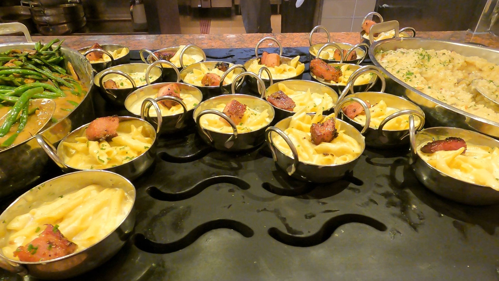 Mini servings of mac and cheese topped with sausage at The Buffet at Wynn