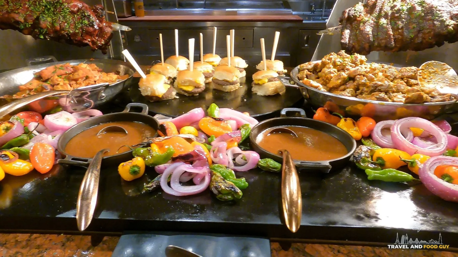 Sliders, chicken wings, and grilled vegetables at the carving station of The Buffet at Wynn