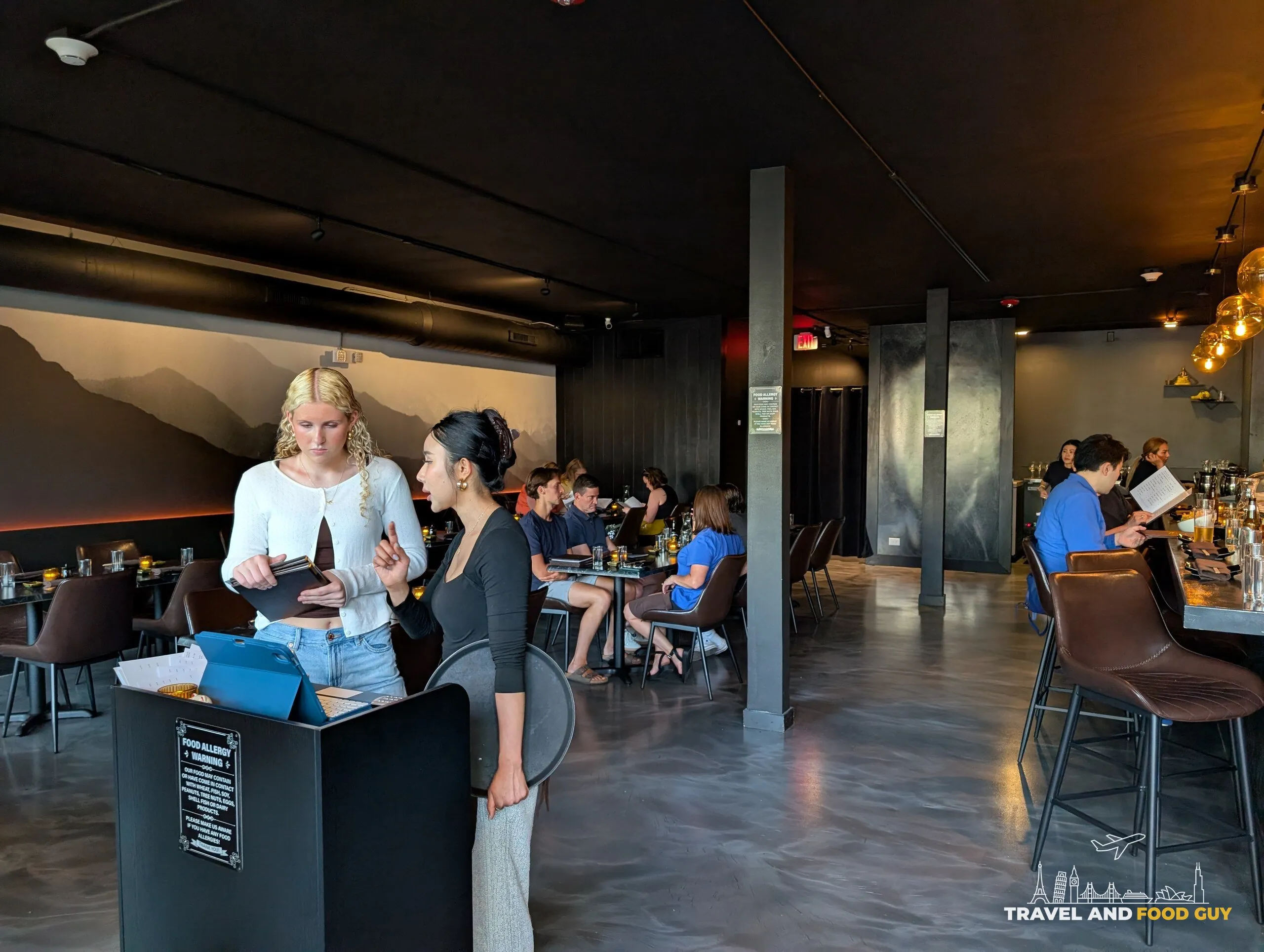 Deba Sushi Bar dining room with mountain mural and host stand