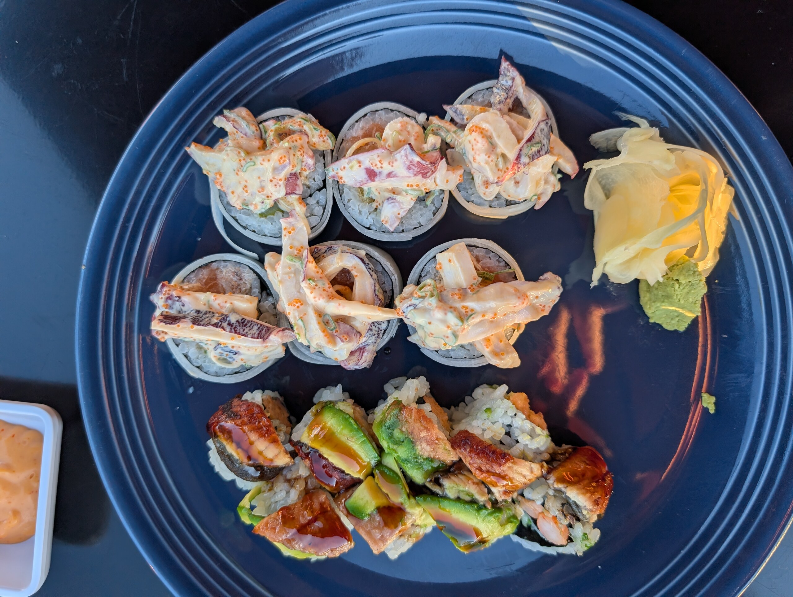 Overhead of Seafoods Mountain and Dragon rolls at Deba Sushi Bar