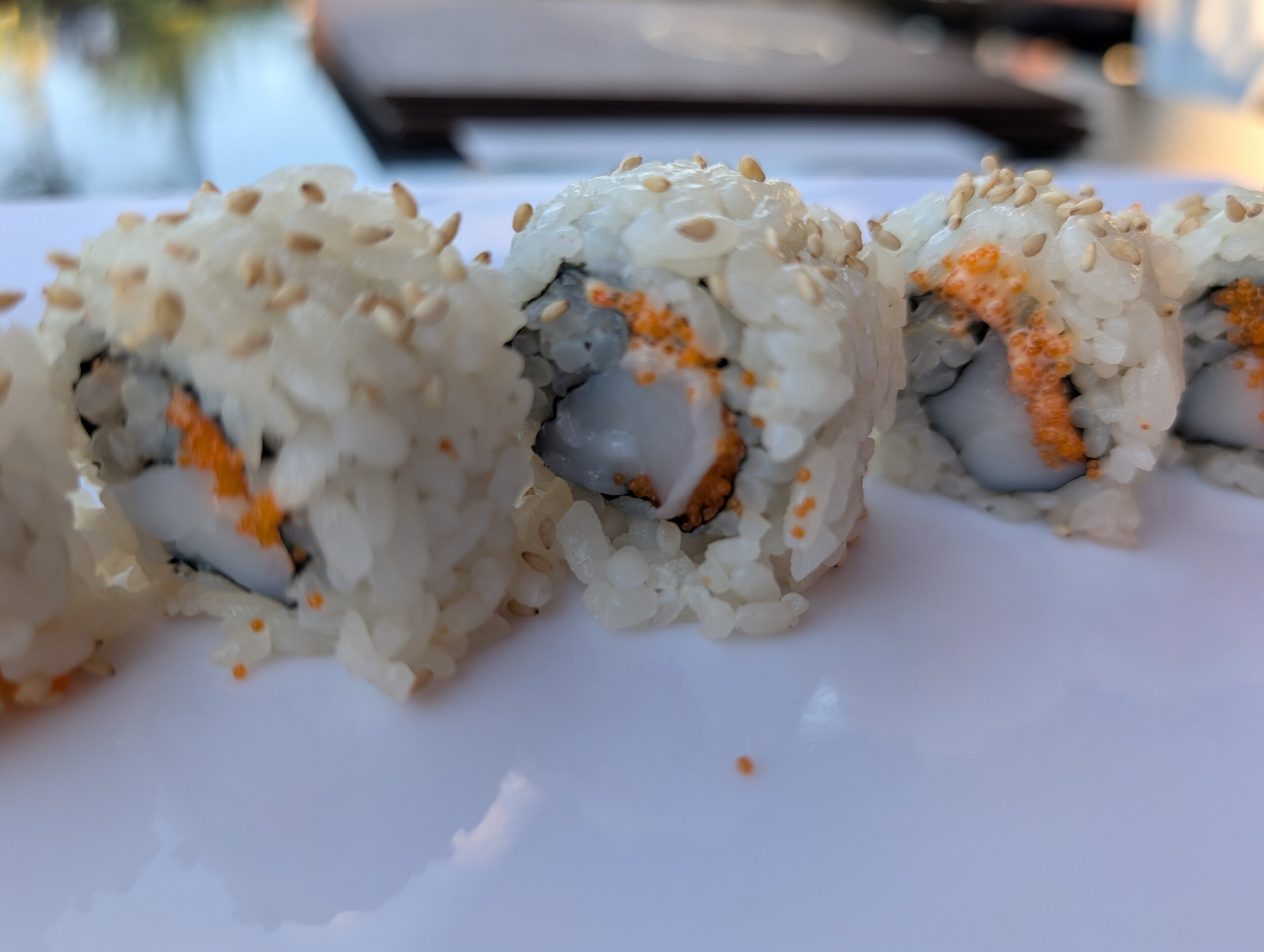 Closeup of the spicy scallop roll at Deba Sushi Bar showing whole scallop pieces