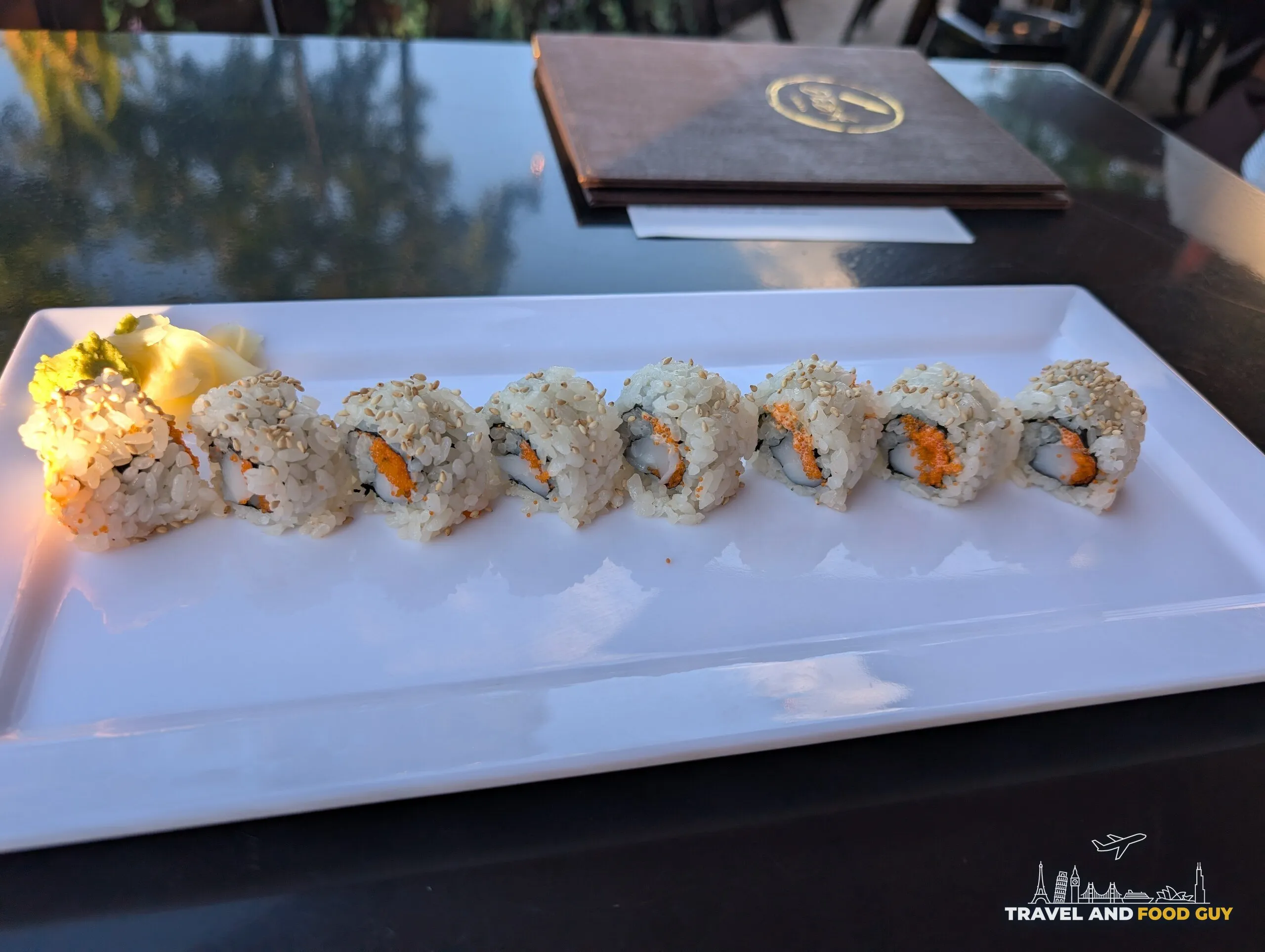 Spicy scallop roll at Deba Sushi Bar topped with sesame and masago