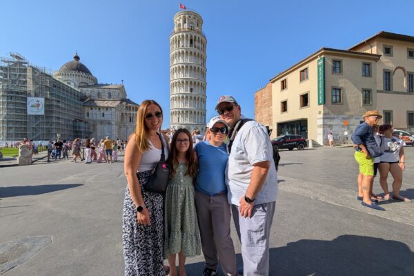 Our family of four in front of the Leaning Tower of Pisa