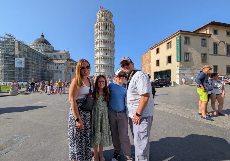 Our family of four in front of the Leaning Tower of Pisa