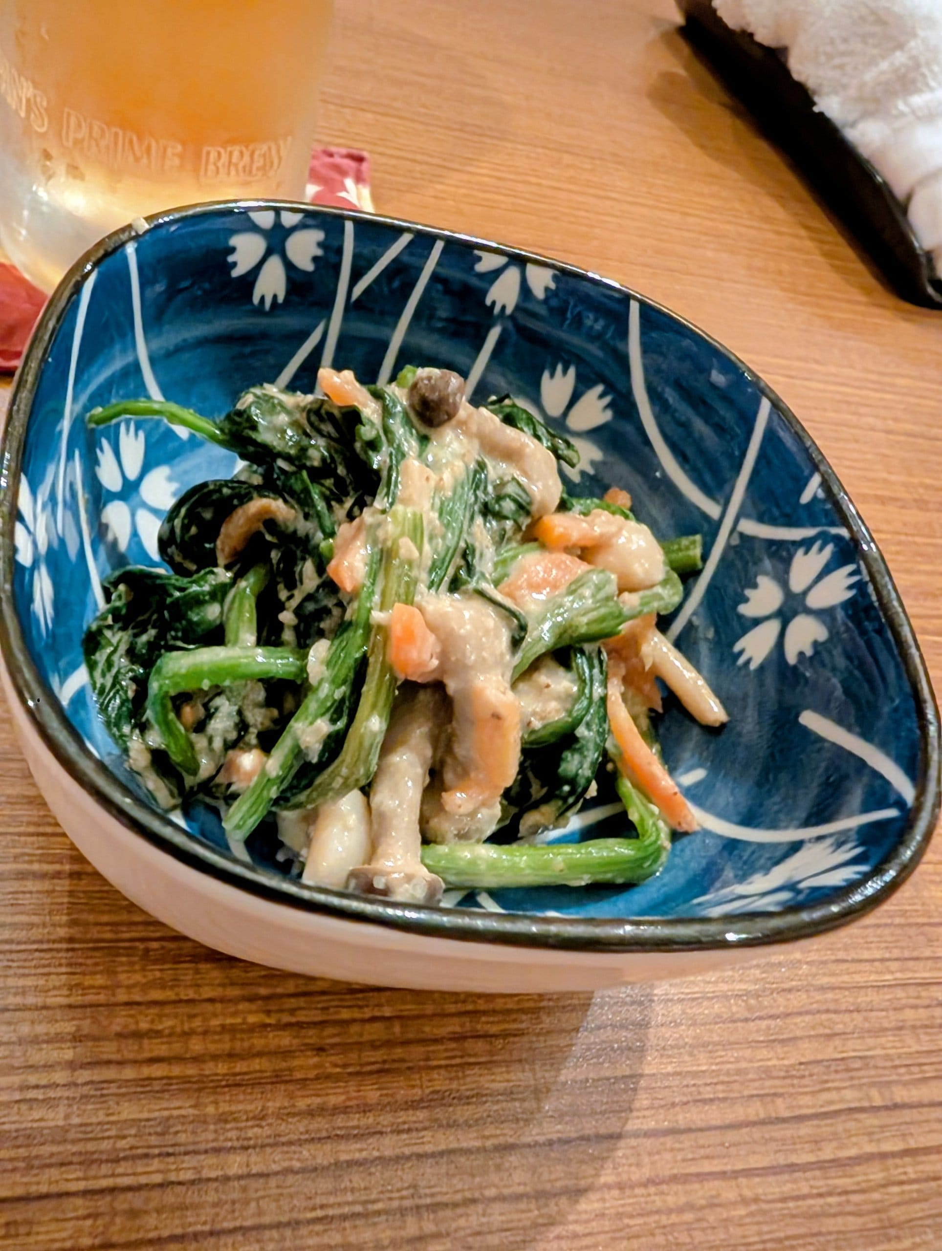Spinach goma-ae with sesame dressing in a blue and white otsumami bowl at Hanashizuku Singapore