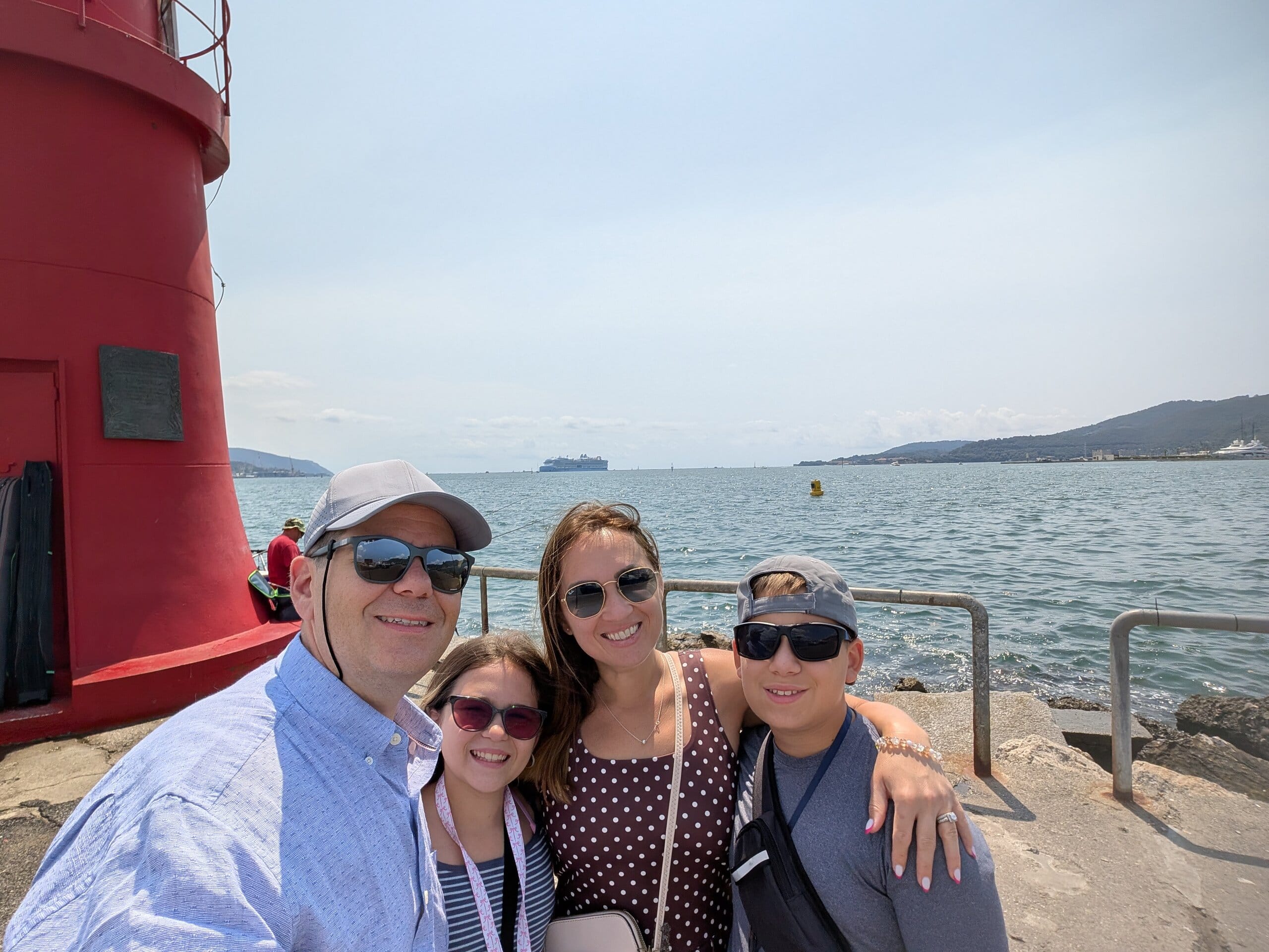 Family photo at the red lighthouse on the La Spezia pier