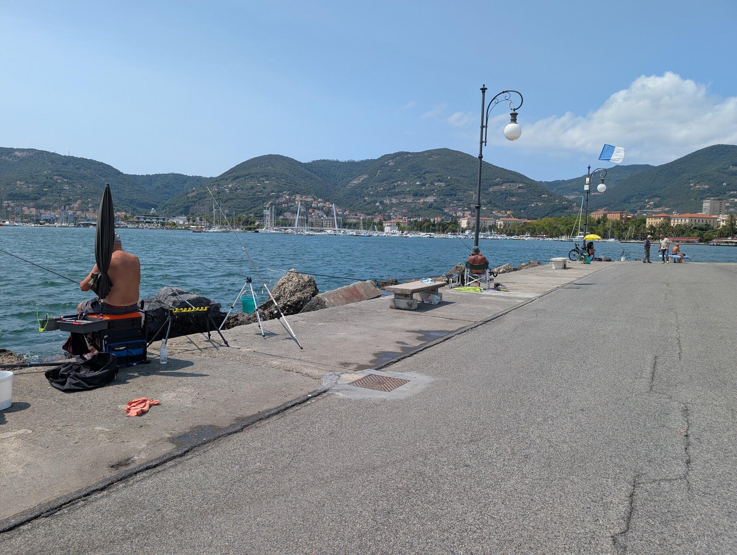 Locals fishing off the pier in La Spezia