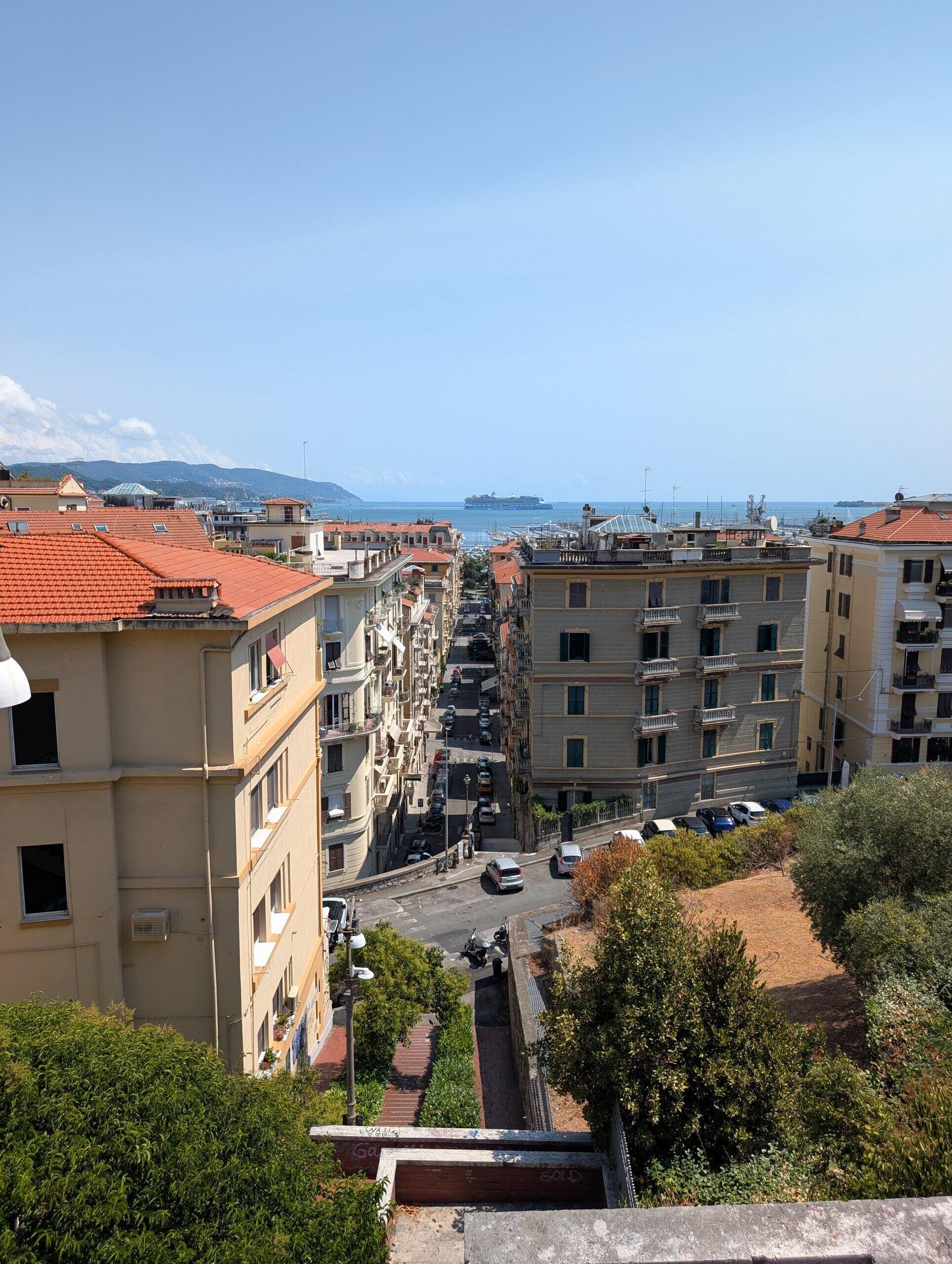 Looking down a La Spezia street to the harbor with the cruise ship at anchor