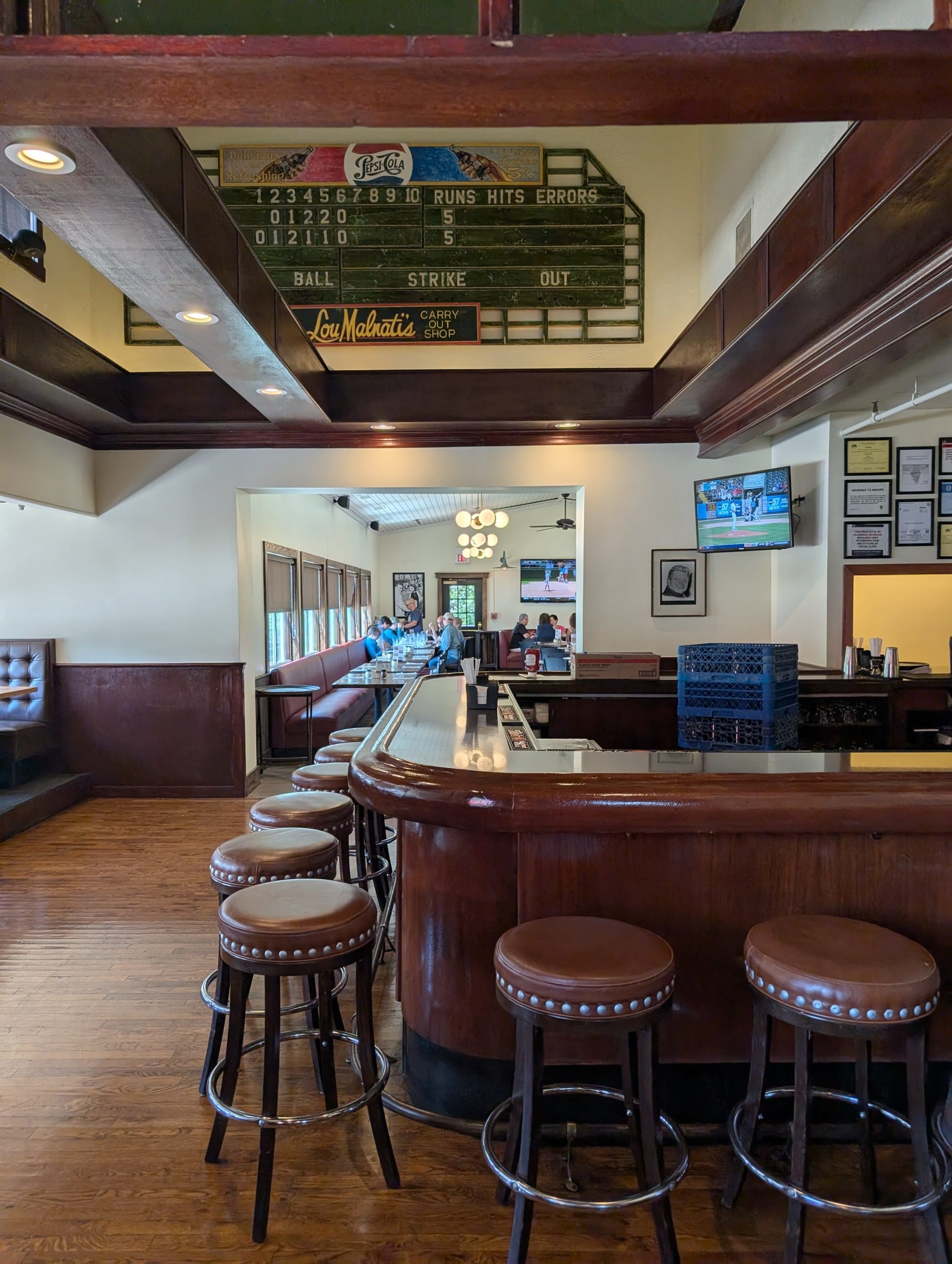Bar at Lou Malnati's Buffalo Grove with a vintage Pepsi baseball scoreboard mounted above it