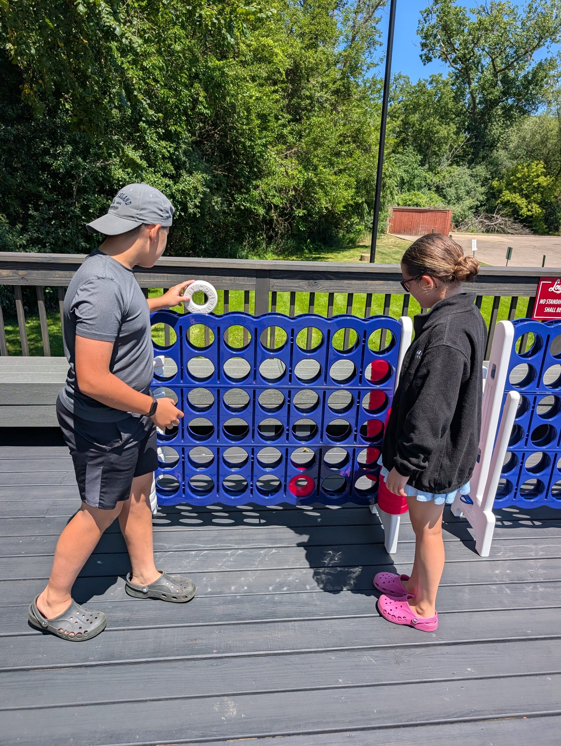 Kids playing giant Connect Four on the patio at Lou Malnati's Buffalo Grove
