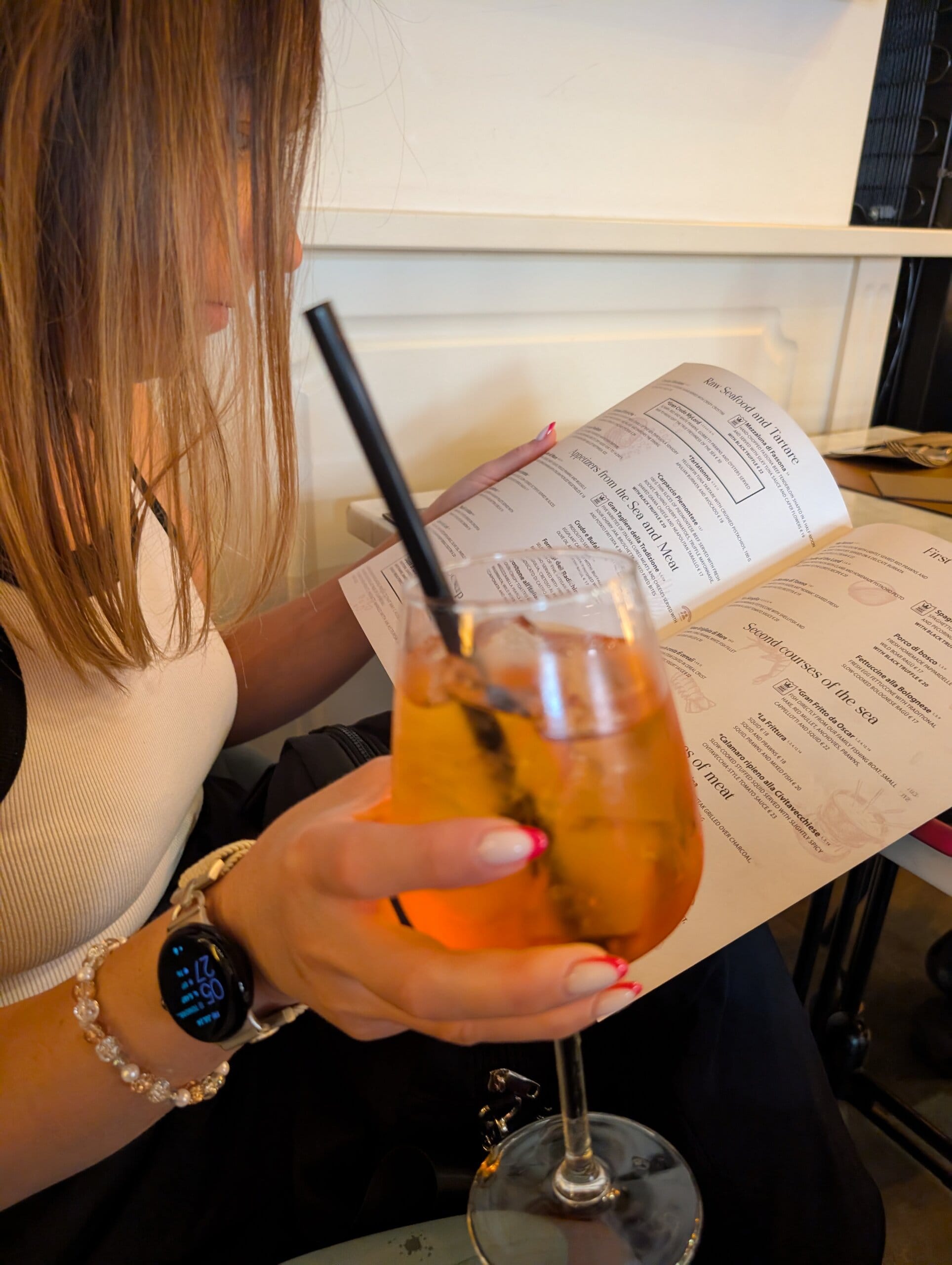 Aperol spritz in hand while reading the English menu at Mylord in Civitavecchia
