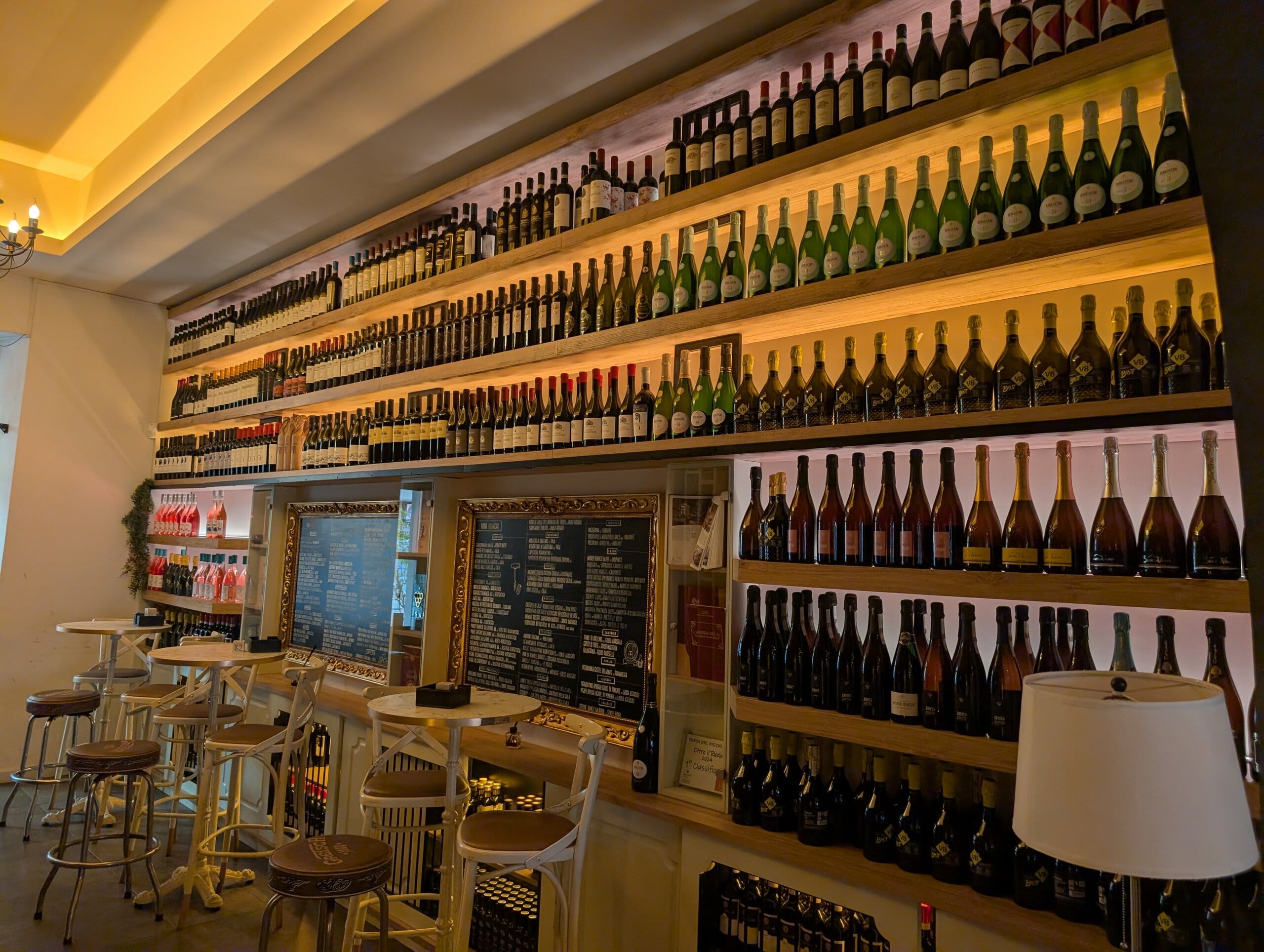 Wall of wine and sparkling bottles at the wine bar room at Mylord in Civitavecchia