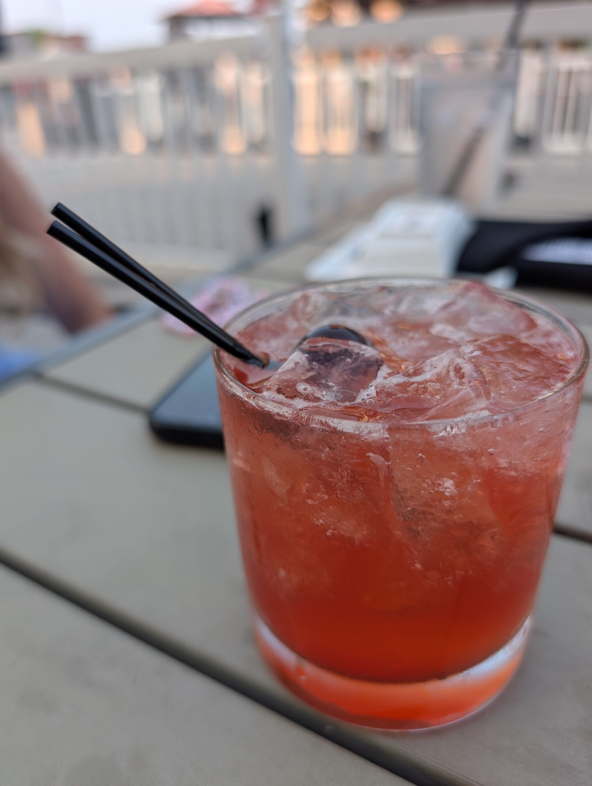 Paper Flame bourbon cocktail at Shakou Arlington Heights, bright red over crushed ice with a cherry