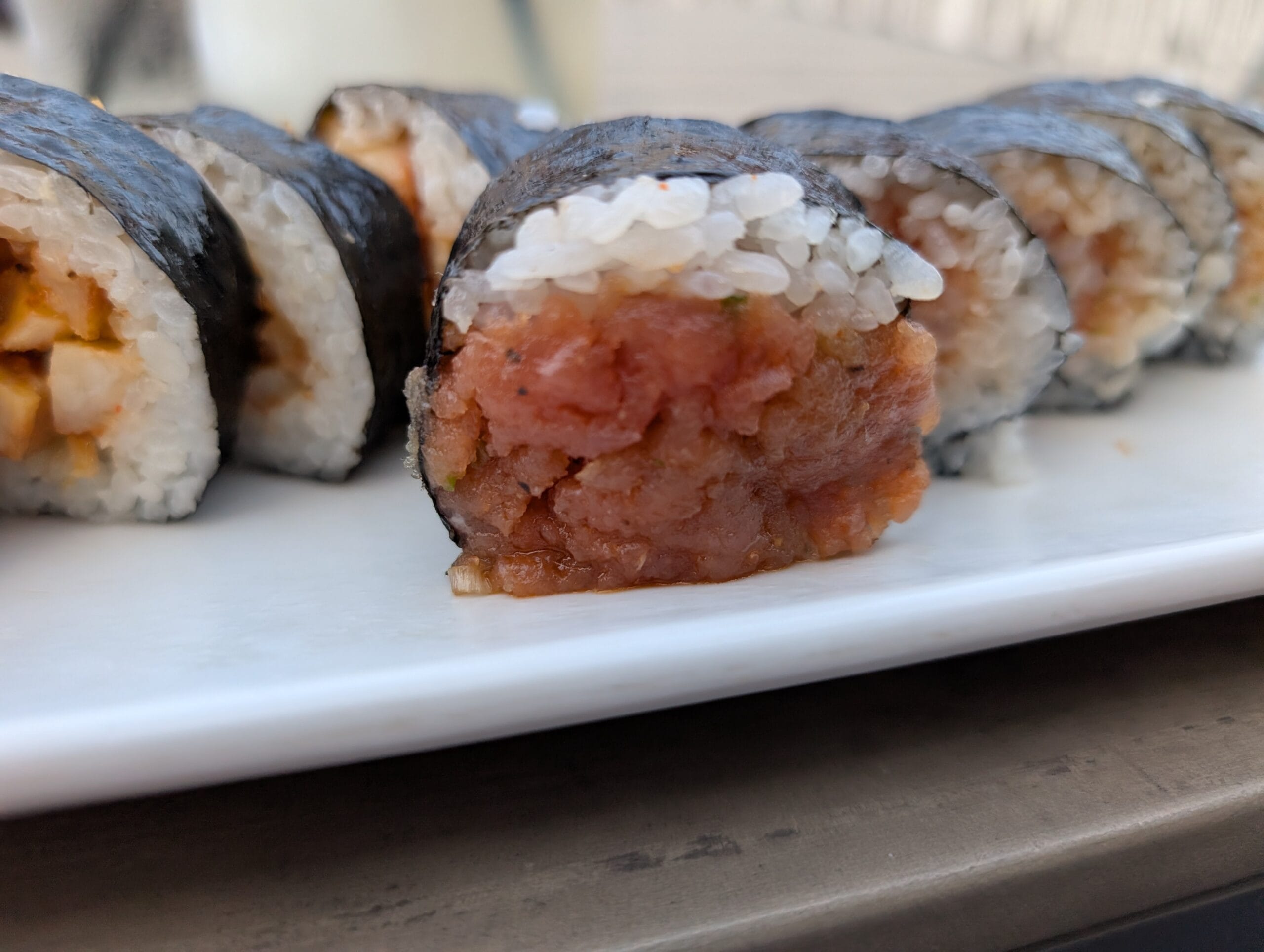 Spicy tuna roll cross section at Shakou Arlington Heights showing chili oil based minced tuna