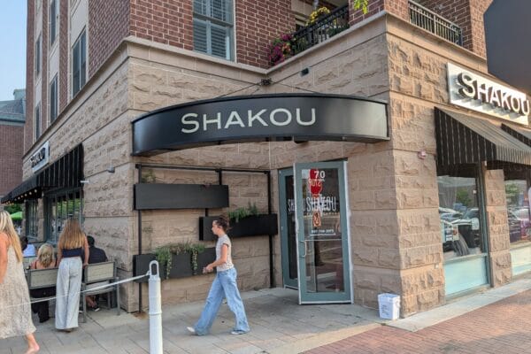 Shakou storefront on the corner of Vail Avenue in downtown Arlington Heights with black awnings and patio seating