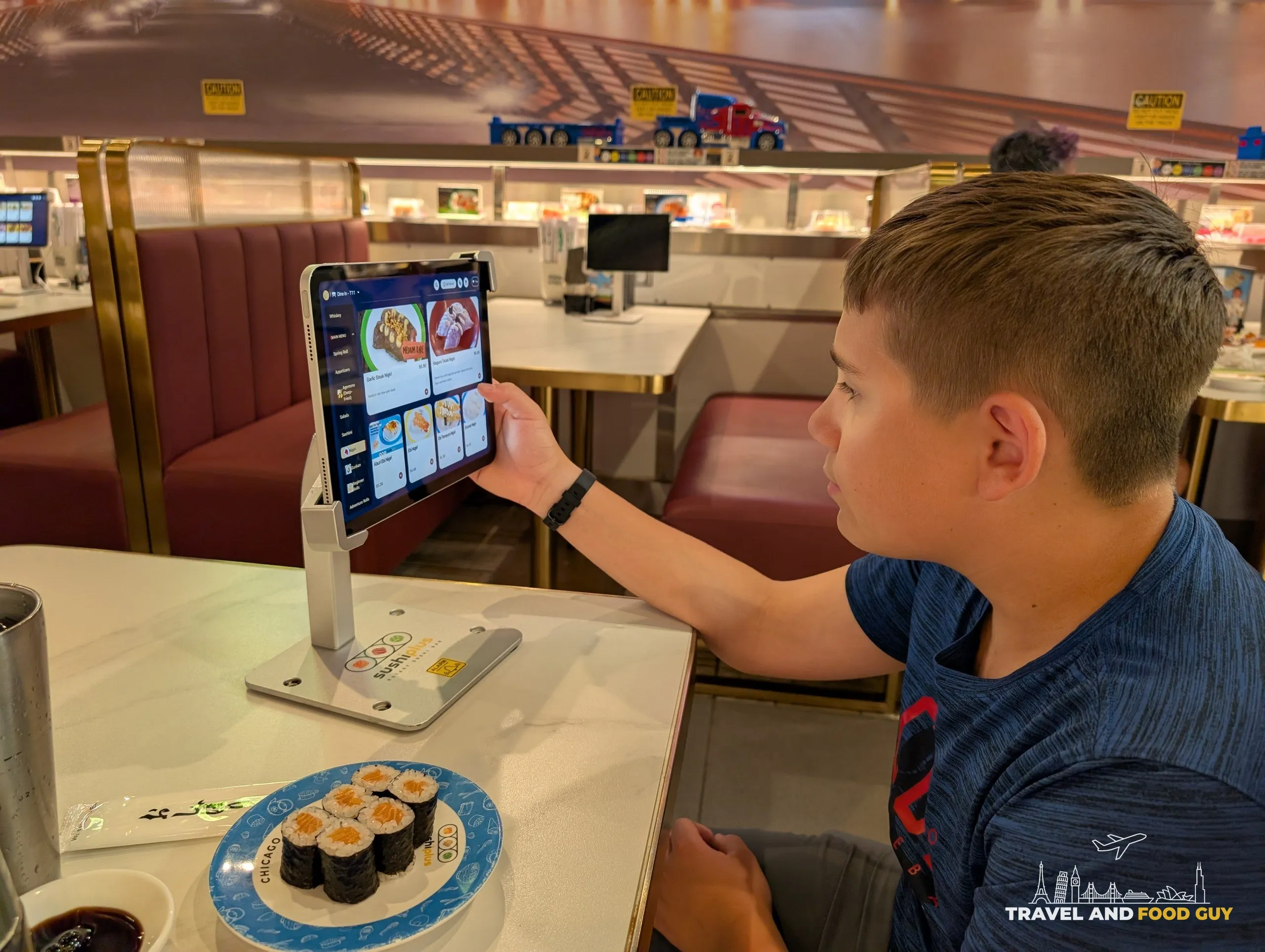 Ordering off the tabletop tablet at Sushi Plus, salmon maki on the plate
