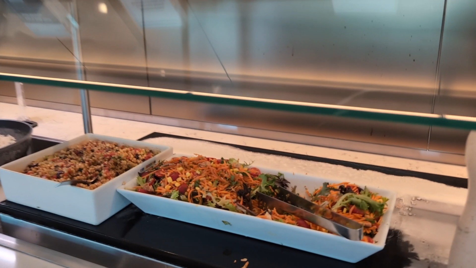 Salads and grain bowls on the buffet at the United Club LAX