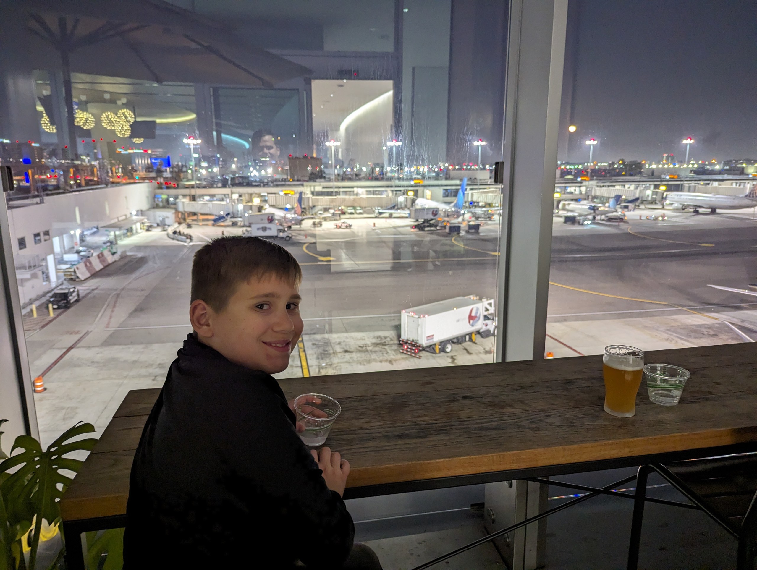 Josh at the counter on the United Club LAX outdoor terrace at night