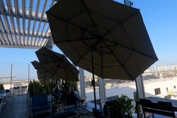 Outdoor terrace at the United Club LAX with umbrellas and lounge seating