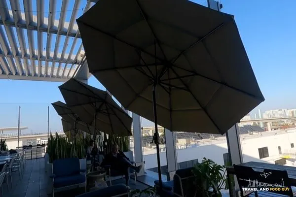 Outdoor terrace at the United Club LAX with umbrellas and lounge seating