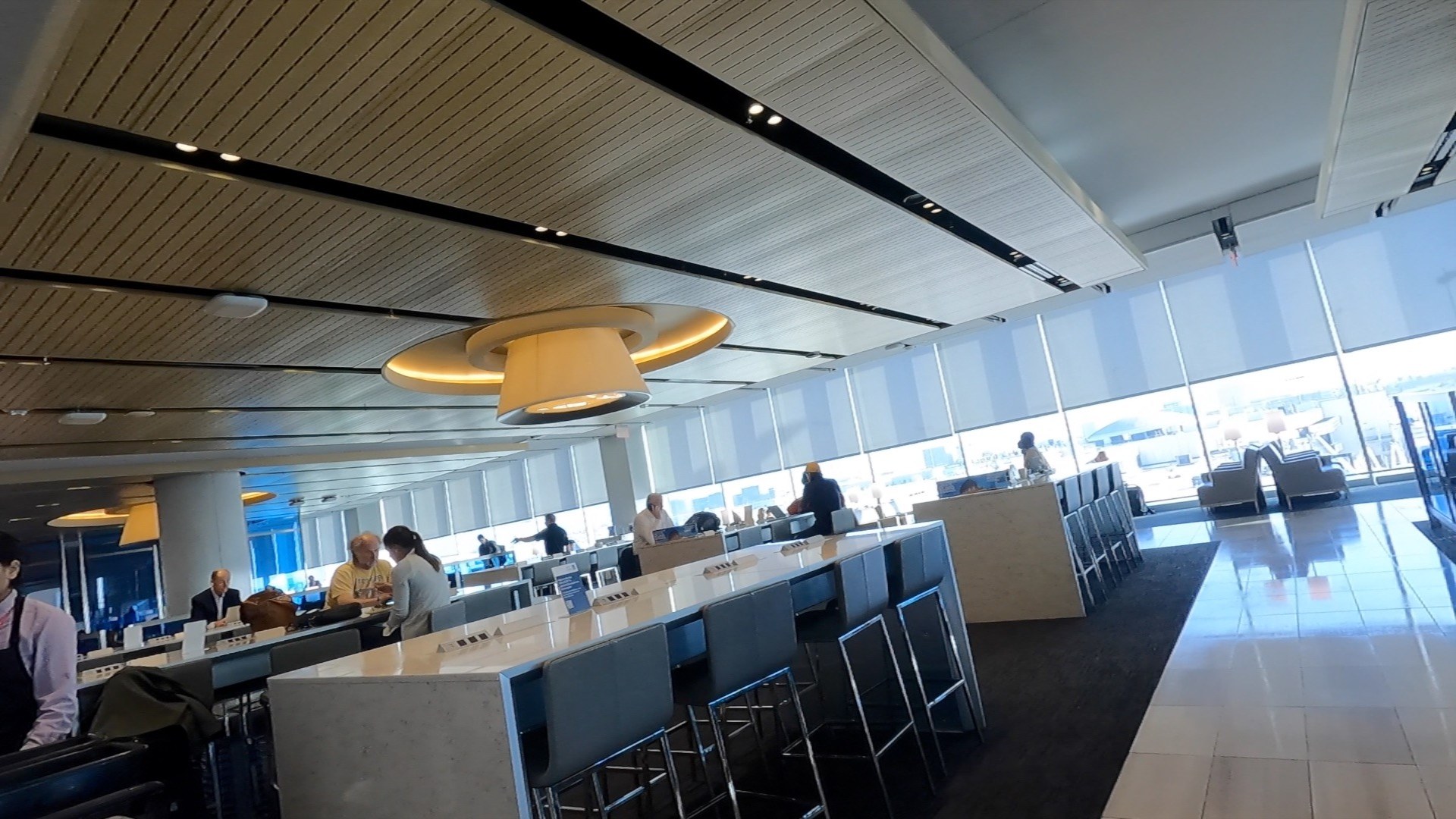 High-top seating with power outlets inside the United Club LAX