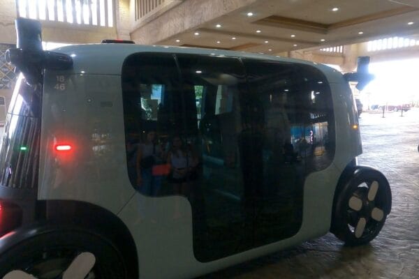 A Zoox driverless robotaxi waiting at a Las Vegas hotel entrance