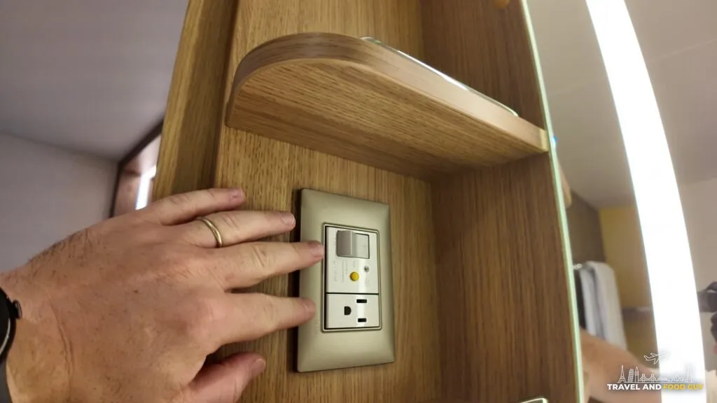 Bathroom power outlet and hook for a razor or hair dryer