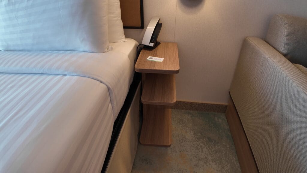 Nightstand with phone and USB charging points in stateroom 14632