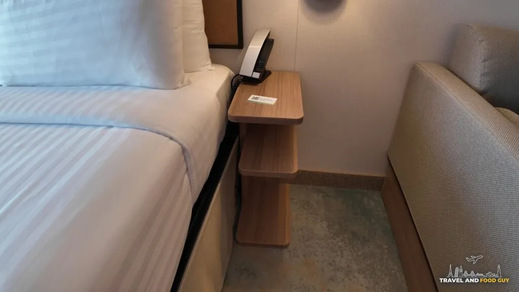 Nightstand with phone and USB charging points in stateroom 14632