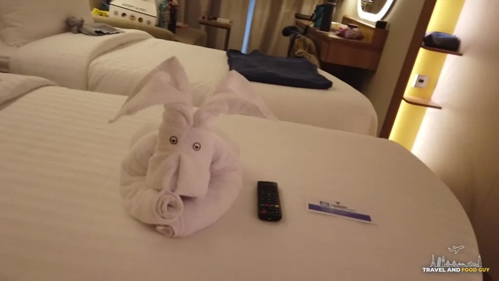 The kids stateroom next door with the beds separated into two twins and a towel elephant