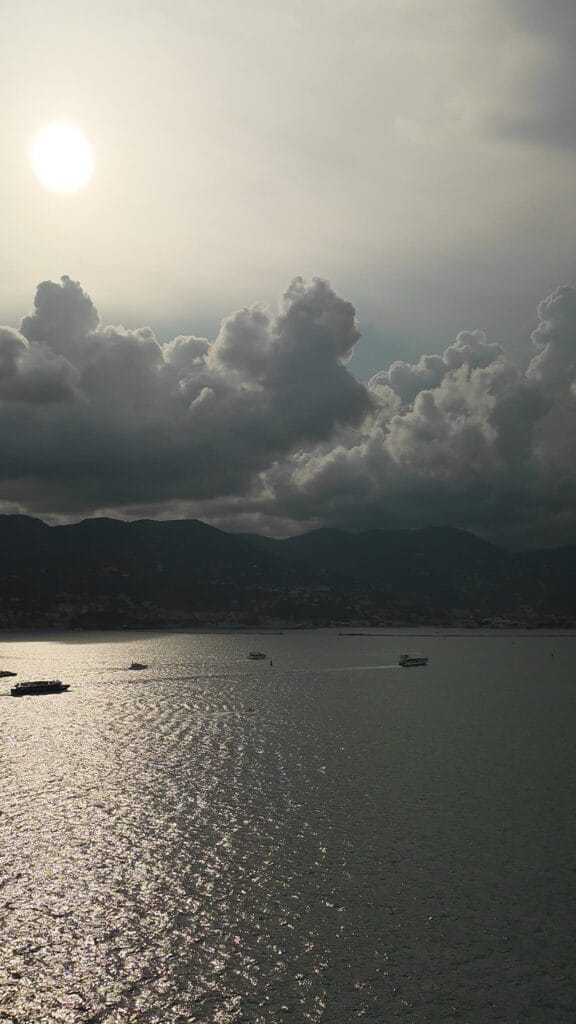Sunrise over the water seen from a Legend of the Seas balcony approaching La Spezia