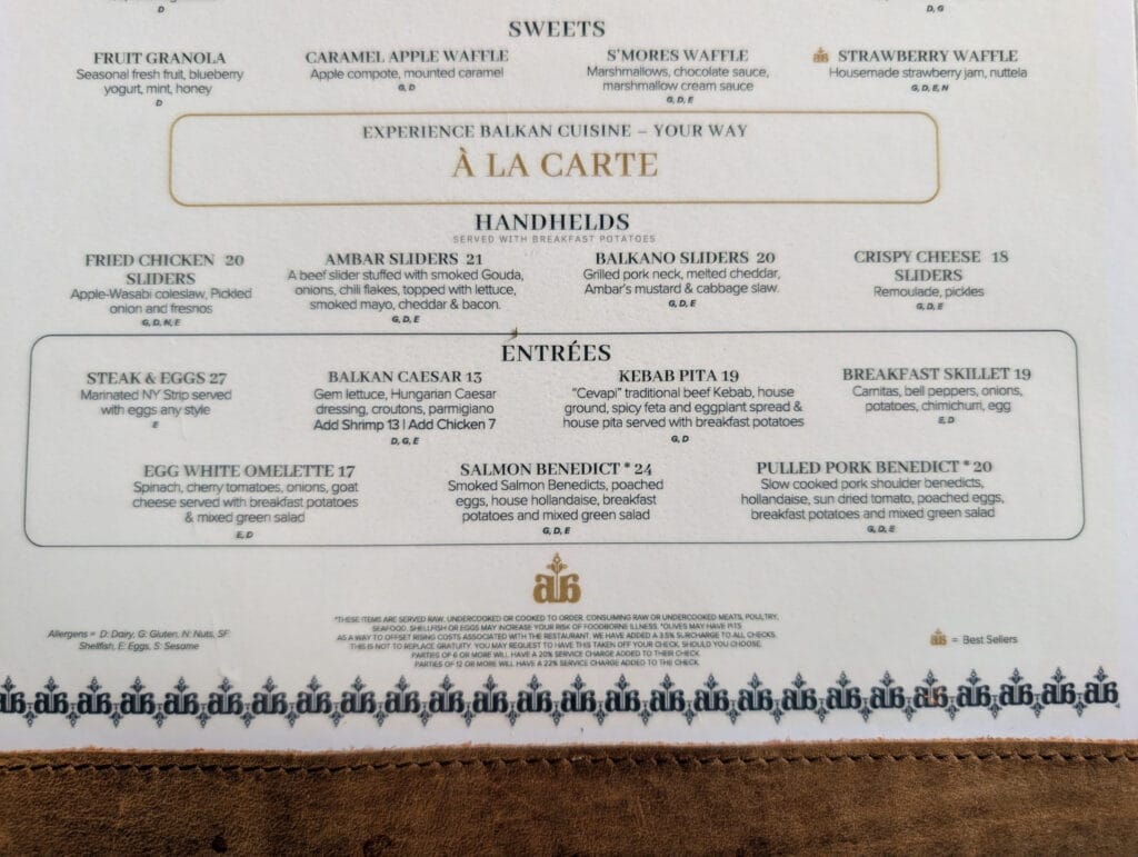 The reverse of the menu lists the a la carte option, including Ambar sliders at twenty one dollars, pulled pork benedict at twenty and steak and eggs at twenty seven.