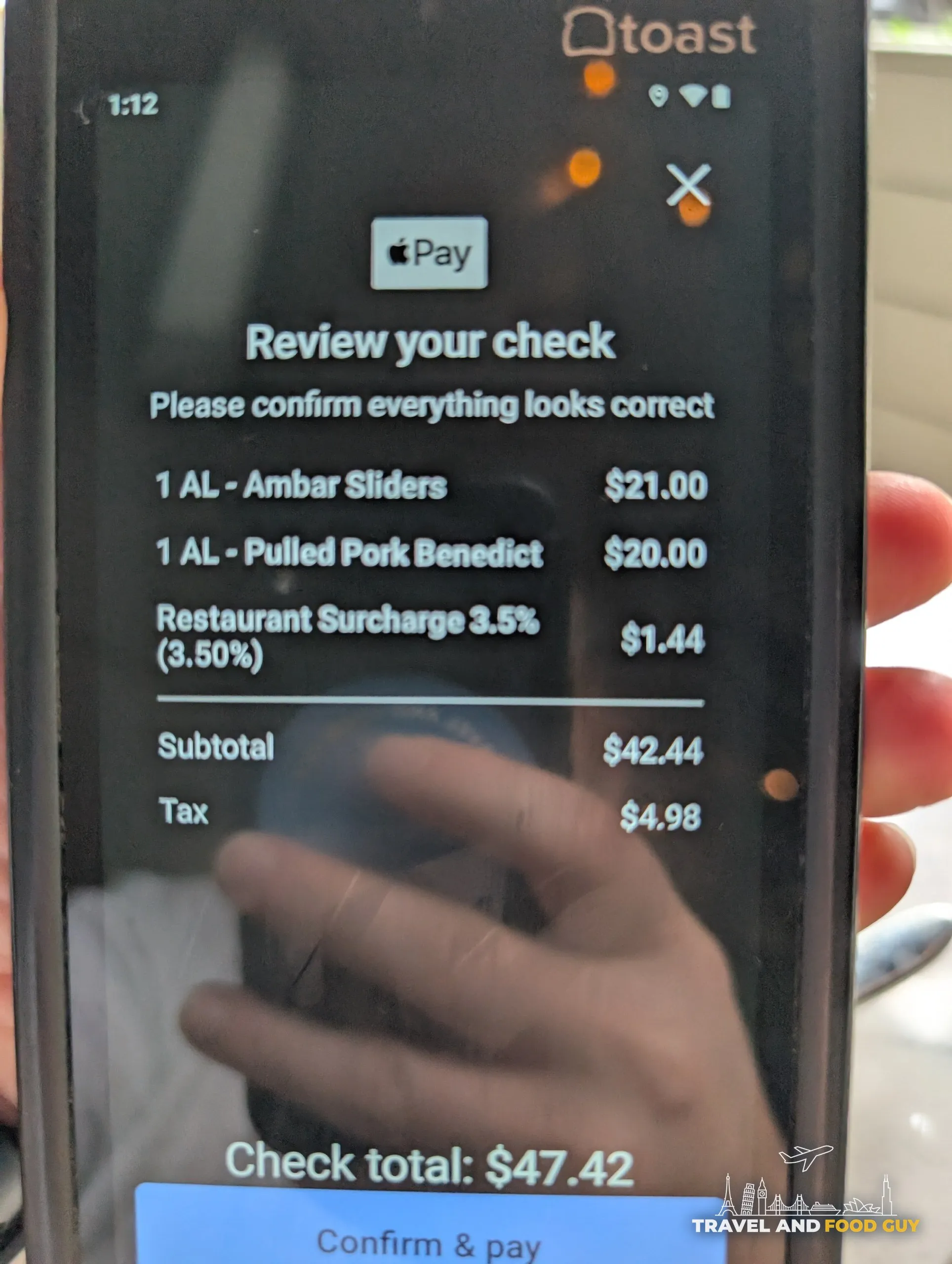 The check shows two a la carte plates, Ambar sliders at twenty one dollars and pulled pork benedict at twenty, a three and a half percent restaurant surcharge, and a total of forty seven dollars and forty two cents.