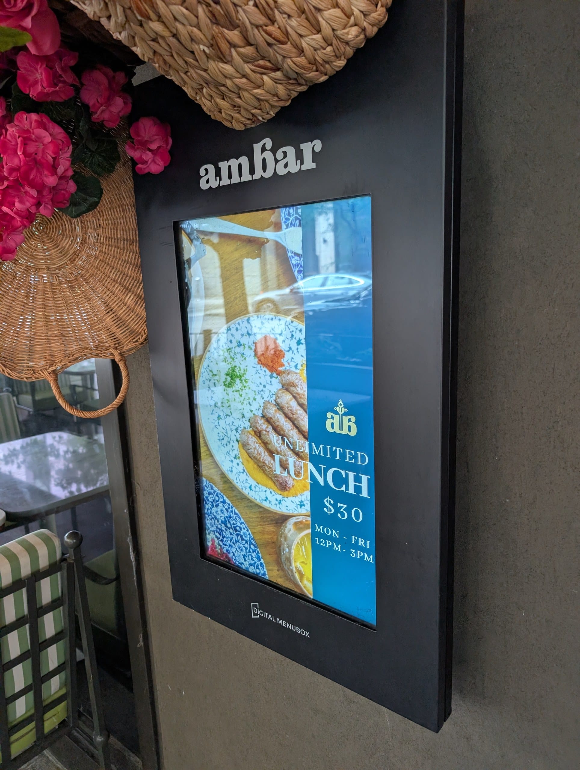 A digital menu box beside the door advertises the unlimited lunch at thirty dollars, Monday through Friday from noon to 3pm.