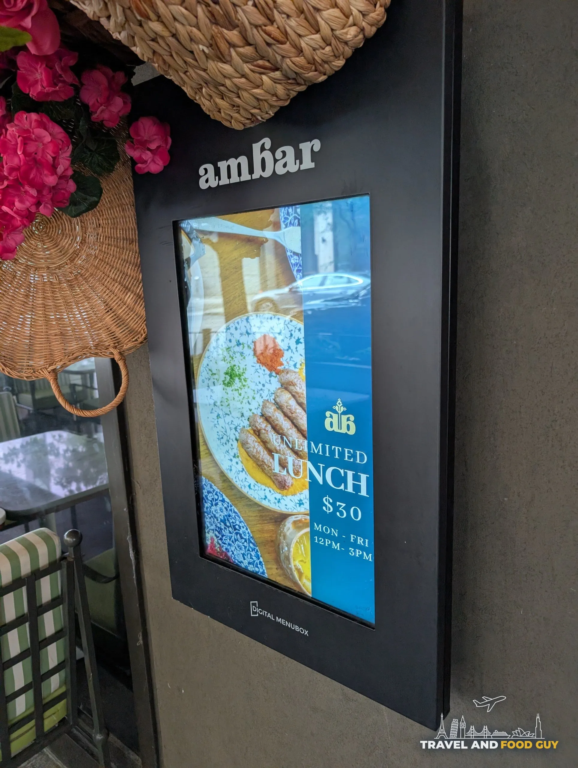 A digital menu box beside the door advertises the unlimited lunch at thirty dollars, Monday through Friday from noon to 3pm.