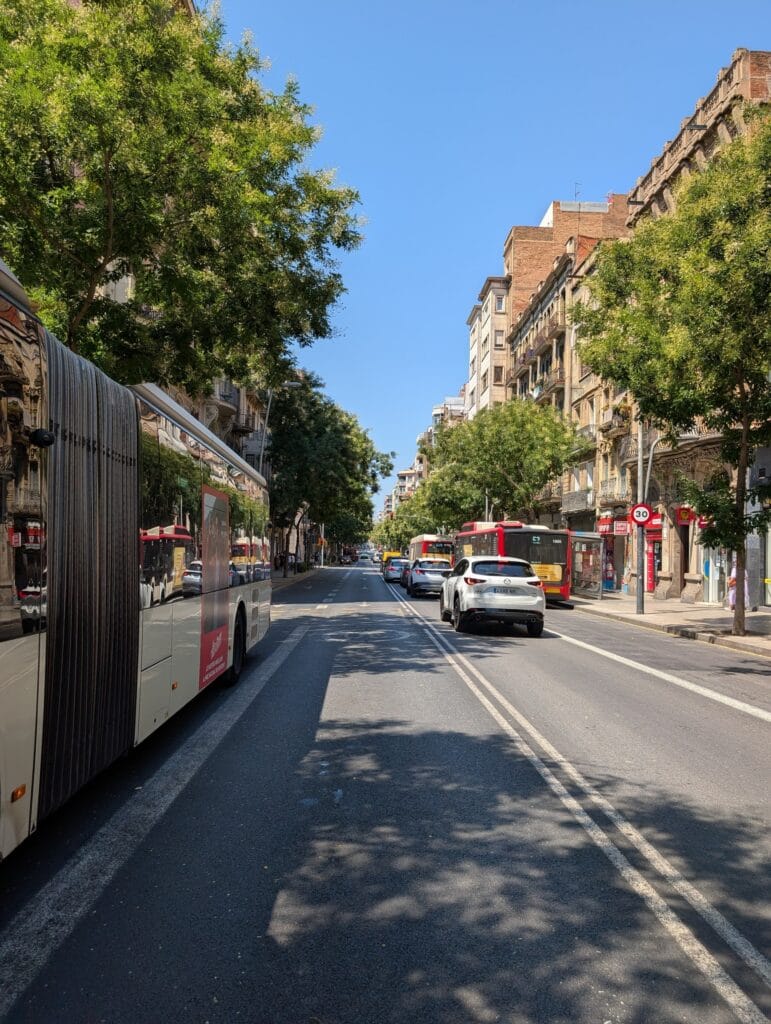 A Barcelona street seen from the open side of the moving tuk tuk