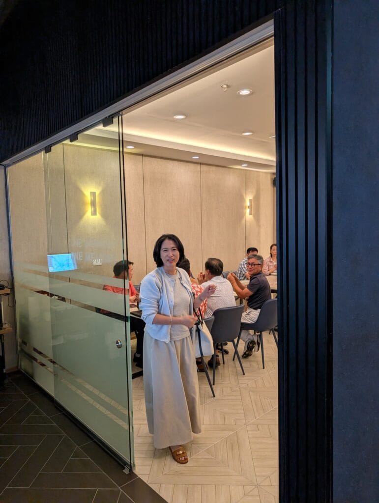 The glassed private room off the main floor, already full while the main dining room was still filling.