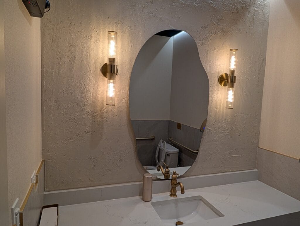 Textured plaster, brass sconces and a stone counter in the restroom, which is usually where the money stops.