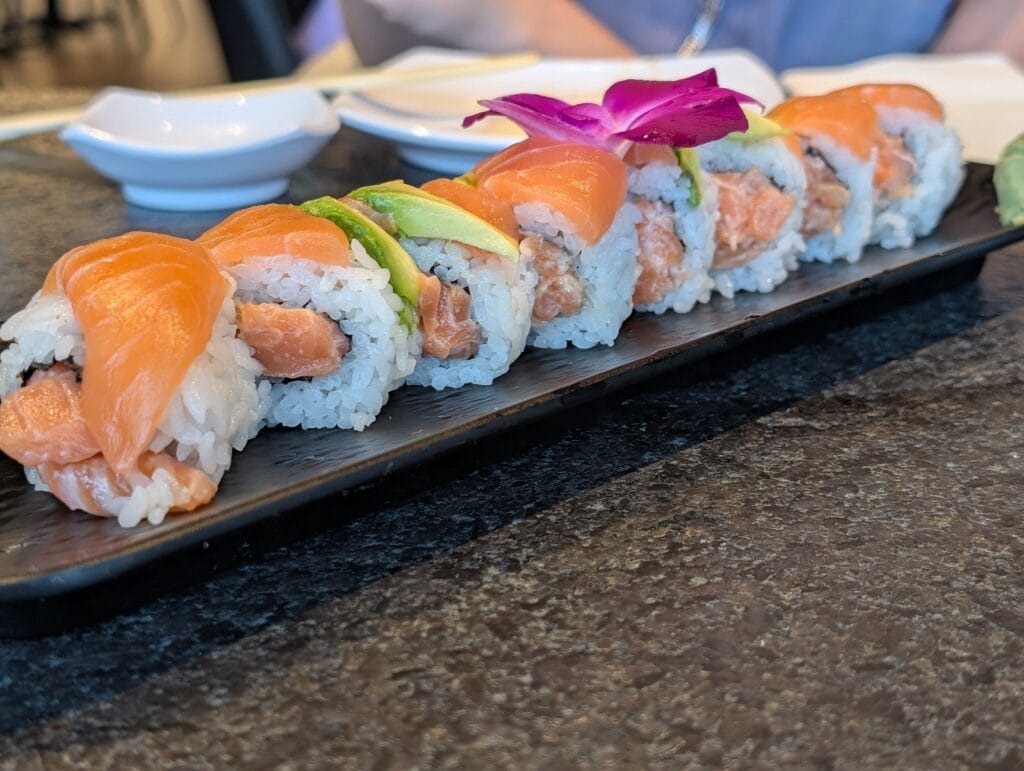 The Sake Aisiteru roll, spicy salmon inside and fresh salmon and avocado on top, fifteen dollars.